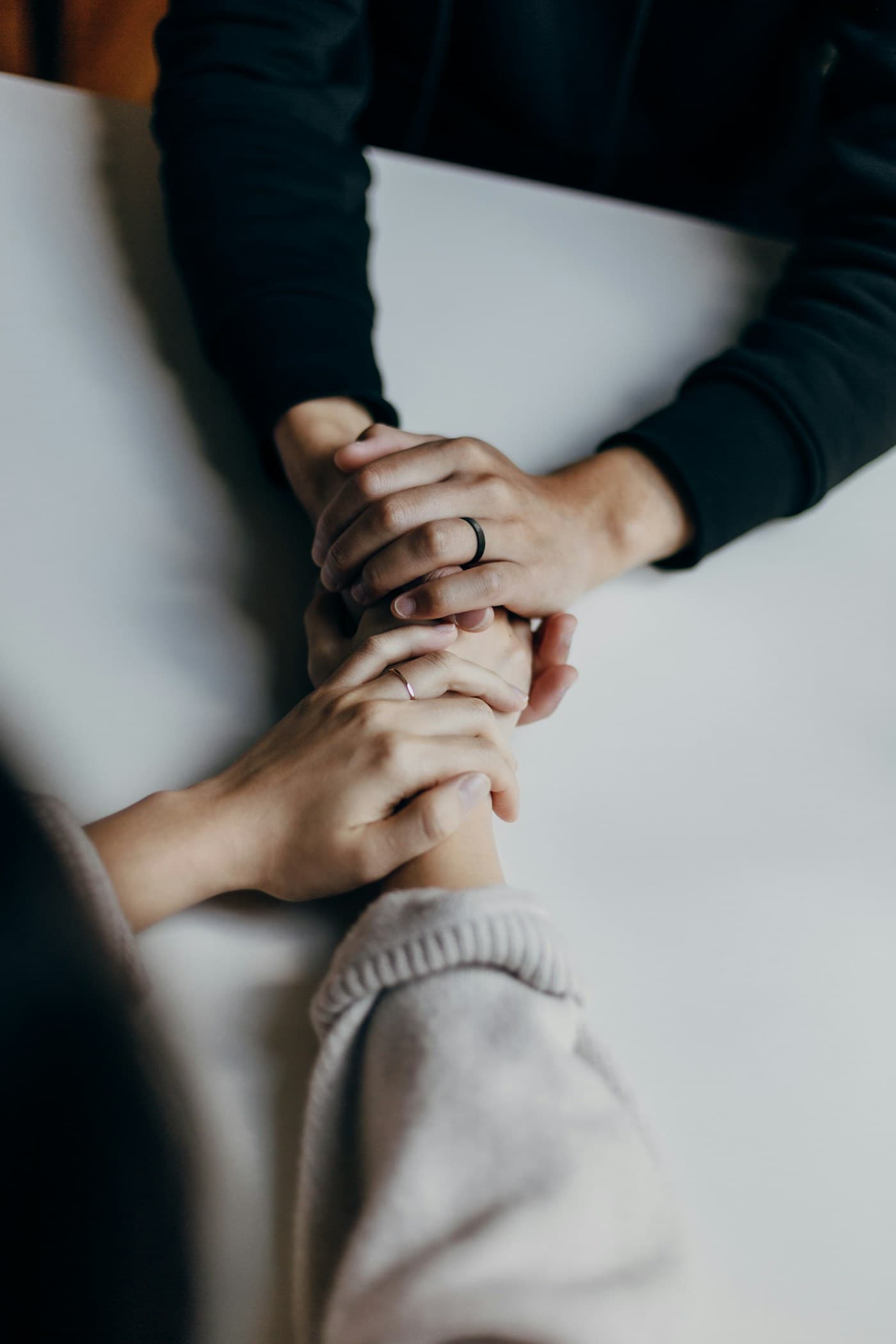 Hands offering support during a mental health conversation